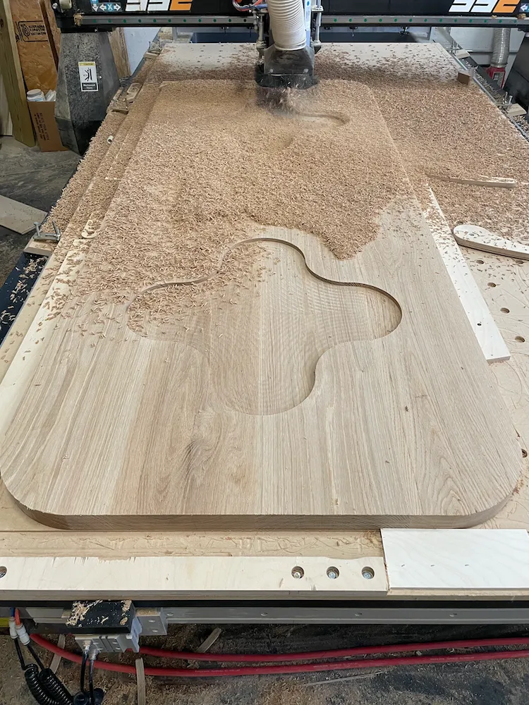 Custom solid white oak tabletop CNC-routed for an Alice + Olivia retail store