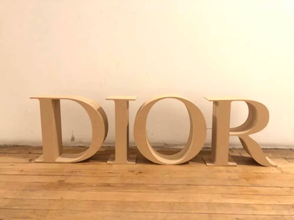 Thick stack-laminated ULMDF letters CNC-routed for a Dior display