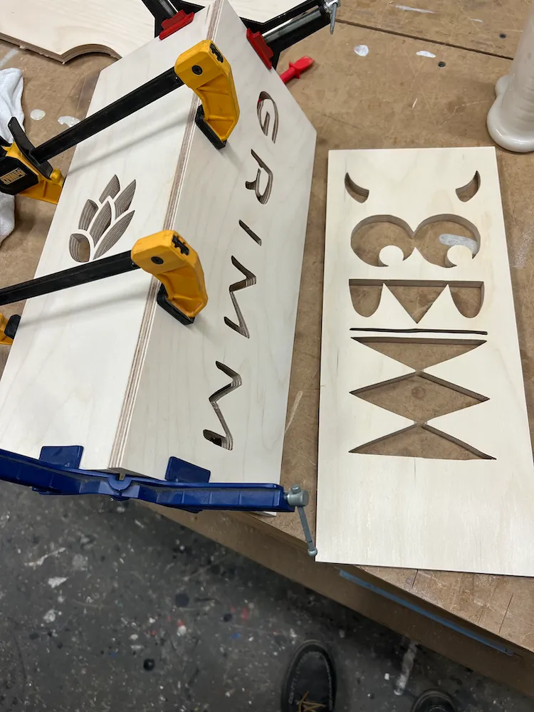 Large candle votive CNC-routed in Baltic birch with the GRIMM logo and icon