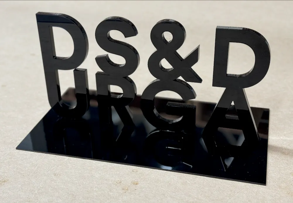 Black three-dimensional laser-cut acrylic display sign for D.S. & Durga
